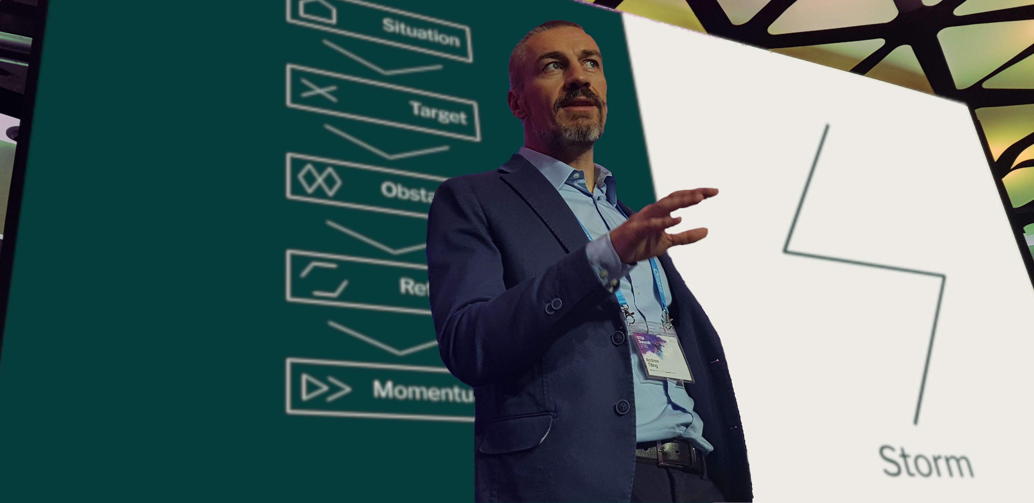 Andrew presenting the STORM Process on stage